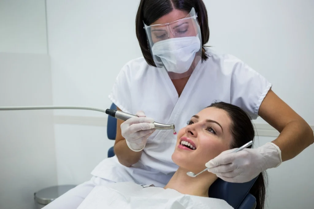 Dentist examining female patient for All on 4 dental implants procedure