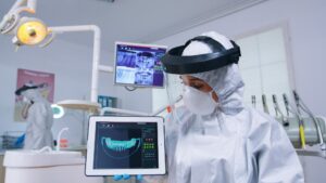 Dentist evaluating digital implant placement on a 3D dental imaging monitor