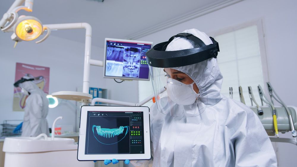 Dentist evaluating digital implant placement on a 3D dental imaging monitor